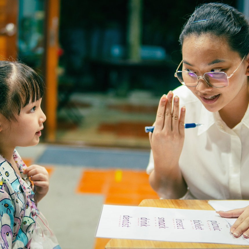 A child writing during a phonics lesson at TEC
