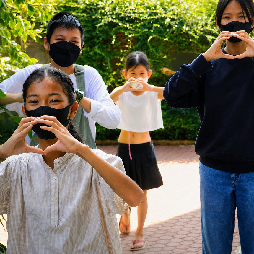 A small group of TEC children outside in the garden